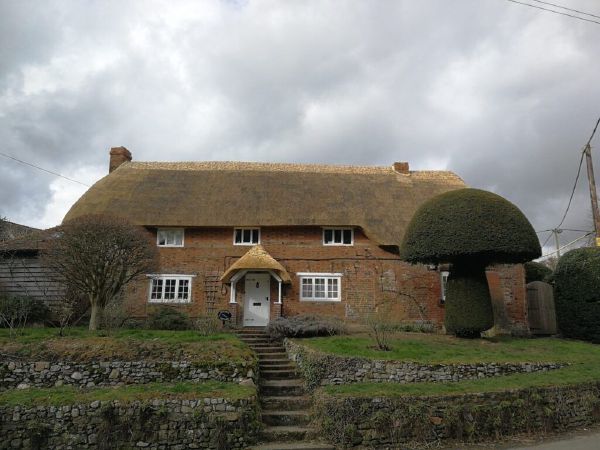 Long straw re-thatch on a rural Wiltshire cottage